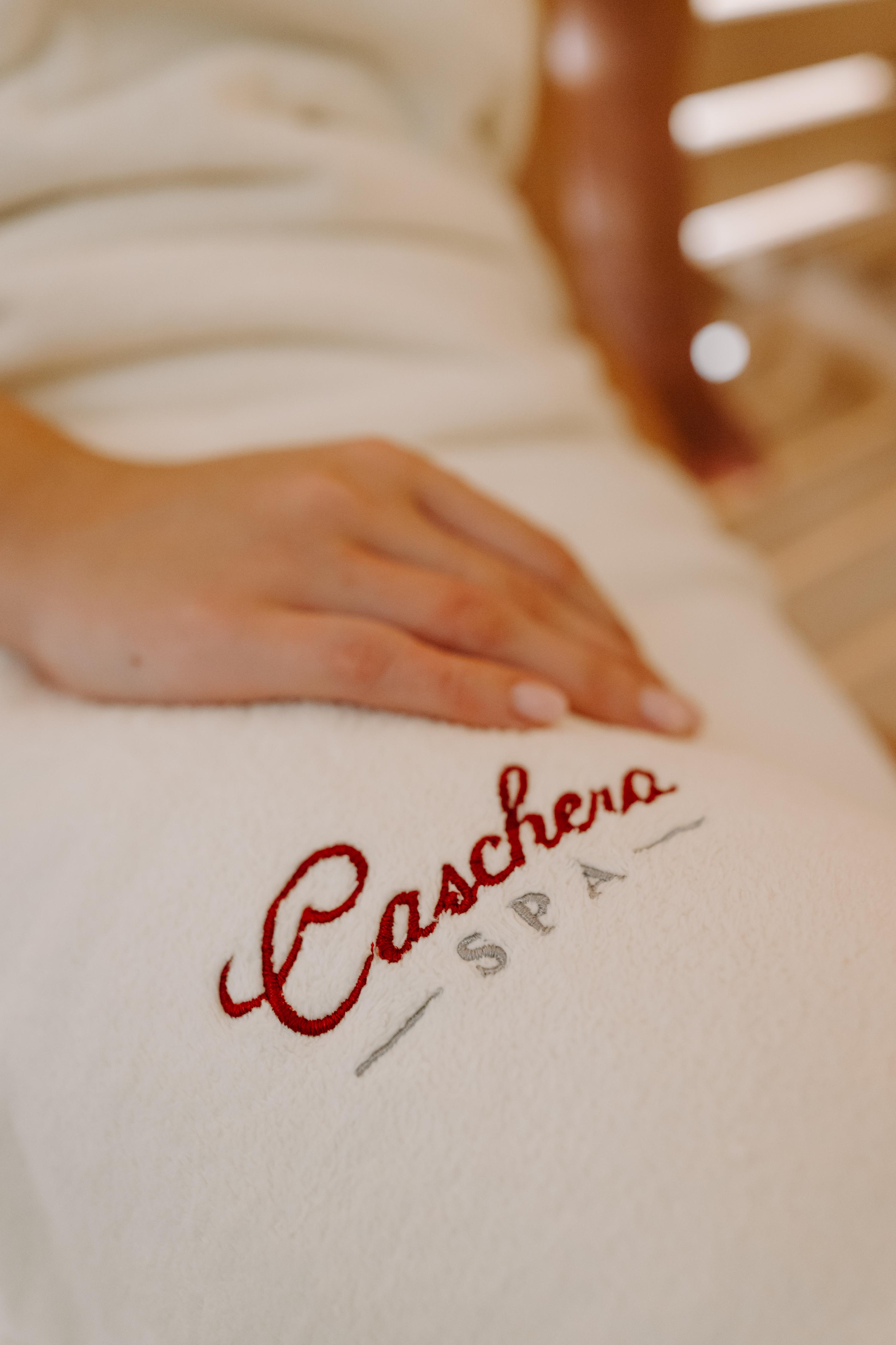 Detail of Caschera SPA logo embroidered on white towel